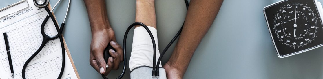 Nurse measuring patient blood pressure